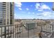 Relaxing balcony overlooking the city skyline, showcasing urban living at its finest with seating and table at 361 17Th Nw St # 807, Atlanta, GA 30363
