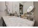 Elegant bathroom vanity with marble countertop, modern fixtures, and decorative mirror with great lighting at 361 17Th Nw St # 807, Atlanta, GA 30363