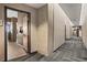 A well-lit hallway with patterned carpet leading to residential units at 361 17Th Nw St # 807, Atlanta, GA 30363