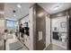 Modern kitchen featuring stainless steel appliances, white cabinets, and a stunning city view from the adjacent living area at 361 17Th Nw St # 807, Atlanta, GA 30363