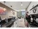 Bright kitchen with stainless steel appliances, black backsplash, and a view into the living area at 361 17Th Nw St # 807, Atlanta, GA 30363