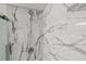 Detailed view of the modern shower featuring sleek, marble-look tile at 361 17Th Nw St # 807, Atlanta, GA 30363