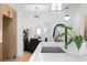 Modern kitchen sink and countertop with view into dining area with modern lighting at 567 Ponce De Leon Ne Ave # 510, Atlanta, GA 30308