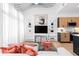 Stylish living room featuring modern shelving, unique lighting fixture, and comfortable seating with decorative pillows at 567 Ponce De Leon Ne Ave # 510, Atlanta, GA 30308