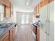 Kitchen with wood cabinets, stainless steel appliances and a door to the dining room at 169 Bethnal Way, Douglasville, GA 30134
