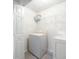 Functional laundry room featuring washer, dryer, and shelving for organized storage at 169 Bethnal Way, Douglasville, GA 30134