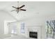 Spacious living room features fireplace, high ceilings, ample natural light and a ceiling fan at 169 Bethnal Way, Douglasville, GA 30134