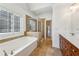 Bathroom featuring a glass-enclosed shower, soaking tub, and double vanity at 2428 Crescent Park Ct, Atlanta, GA 30339