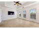 Bedroom with carpet, multiple windows, ceiling fan and mounted television at 2428 Crescent Park Ct, Atlanta, GA 30339