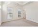 Cozy bedroom featuring neutral carpeting, bright windows, and an accessible doorway at 2428 Crescent Park Ct, Atlanta, GA 30339