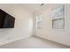 Bright, carpeted bedroom with two large windows and modern TV, offering comfort and convenience at 2428 Crescent Park Ct, Atlanta, GA 30339