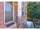 Close-up of brick townhome front door and steps with black metal railings at 2428 Crescent Park Ct, Atlanta, GA 30339