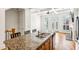 Granite countertop island with double sink overlooking the living area with coffered ceilings and fireplace at 2428 Crescent Park Ct, Atlanta, GA 30339