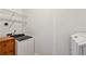 Laundry room featuring a washer, dryer, utility sink and wire shelving at 2428 Crescent Park Ct, Atlanta, GA 30339