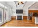 Living room view showcasing a fireplace, built-ins, and kitchen access with stainless steel appliances at 2428 Crescent Park Ct, Atlanta, GA 30339