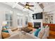 Cozy living room featuring fireplace, hardwood floors, coffered ceilings, and plantation shutters at 2428 Crescent Park Ct, Atlanta, GA 30339