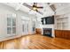 Open concept living room with hardwood floors, fireplace, built-in shelves and cabinets, and coffered ceilings at 2428 Crescent Park Ct, Atlanta, GA 30339