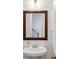 Powder room featuring a pedestal sink with mirror and decorative accents at 2428 Crescent Park Ct, Atlanta, GA 30339