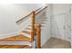 Wood staircase with metal railings and tile landing, providing a blend of classic and modern design at 2428 Crescent Park Ct, Atlanta, GA 30339