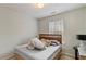 Cozy bedroom showcasing a window with natural light and neutral-toned walls at 6327 Ellenwood Dr, Rex, GA 30273