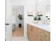 Bright bathroom features a modern vanity with wood cabinets and sleek hardware, offering a view into the adjacent room at 567 Ponce De Leon Ne Ave # 614, Atlanta, GA 30308