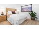 Bright bedroom features a tan headboard, white linens, neutral rug and modern artwork, creating a serene retreat at 567 Ponce De Leon Ne Ave # 614, Atlanta, GA 30308