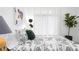 Bright bedroom with modern floral bedding, contemporary lighting, sheer curtains, and unique side table at 567 Ponce De Leon Ne Ave # 614, Atlanta, GA 30308