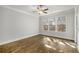 Bedroom with hardwood floors, ceiling fan, and natural light at 685 Stickley Oak Way, Woodstock, GA 30189