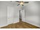 This bedroom features hardwood floors, a ceiling fan and two doors offering both convenience and style at 685 Stickley Oak Way, Woodstock, GA 30189