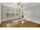 A bright bedroom features hardwood floors and many windows with outdoor views at 685 Stickley Oak Way, Woodstock, GA 30189