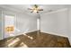 Large room featuring hardwood floors, a ceiling fan and access to the porch at 685 Stickley Oak Way, Woodstock, GA 30189