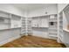 Walk-in closet with built in shelving and hardwood floors at 685 Stickley Oak Way, Woodstock, GA 30189