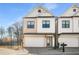 Charming two-story home with a stone and siding exterior, a two-car garage, and a well-manicured front yard at 685 Stickley Oak Way, Woodstock, GA 30189