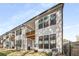 Modern townhome exterior showcasing a wooden balcony and a white siding at 685 Stickley Oak Way, Woodstock, GA 30189