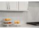 Chevron tile backsplash complements the white cabinets and countertops at 685 Stickley Oak Way, Woodstock, GA 30189
