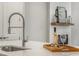 Close up of island sink, faucet, wine and decor at 685 Stickley Oak Way, Woodstock, GA 30189