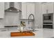 Close-up of kitchen island with sink, faucet, and decorative tray at 685 Stickley Oak Way, Woodstock, GA 30189