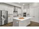 Modern kitchen featuring white cabinets, stainless steel appliances, and a large center island at 685 Stickley Oak Way, Woodstock, GA 30189