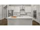 Modern kitchen with white cabinets, stainless steel appliances, and a large center island and breakfast bar at 685 Stickley Oak Way, Woodstock, GA 30189