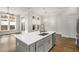 Bright open kitchen with quartz countertops, stainless steel appliances, and hardwood floors at 685 Stickley Oak Way, Woodstock, GA 30189