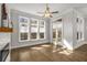 Bright living room featuring hardwood floors, a ceiling fan and a fireplace at 685 Stickley Oak Way, Woodstock, GA 30189