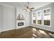 Bright living room with fireplace, large windows, and hardwood floors at 685 Stickley Oak Way, Woodstock, GA 30189