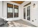 A well-lit outdoor patio area with crisp white siding and a modern outdoor light fixture at 685 Stickley Oak Way, Woodstock, GA 30189