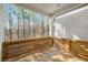 Outdoor porch features wooden floors and a wooded view at 685 Stickley Oak Way, Woodstock, GA 30189