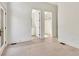 Bedroom featuring hardwood floors and view of bathroom and walk-in closet at 115 Arcadia Ave, Fayetteville, GA 30214