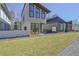 Contemporary two-story home featuring large windows, sleek design, and well-manicured lawn at 115 Arcadia Ave, Fayetteville, GA 30214