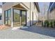 Close-up of a modern home's entrance with large glass door, gravel landscaping, and sleek design at 115 Arcadia Ave, Fayetteville, GA 30214