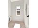 Laundry room with white walls, light wood floor, and natural light at 115 Arcadia Ave, Fayetteville, GA 30214