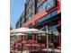 Outdoor dining patio at Enzo Steakhouse with stylish red seating under umbrellas, offering a vibrant dining experience at 115 Arcadia Ave, Fayetteville, GA 30214