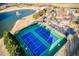 Aerial view of community tennis courts and pond surrounded by trees and landscaping at 1205 Trey Ct, Marietta, GA 30064